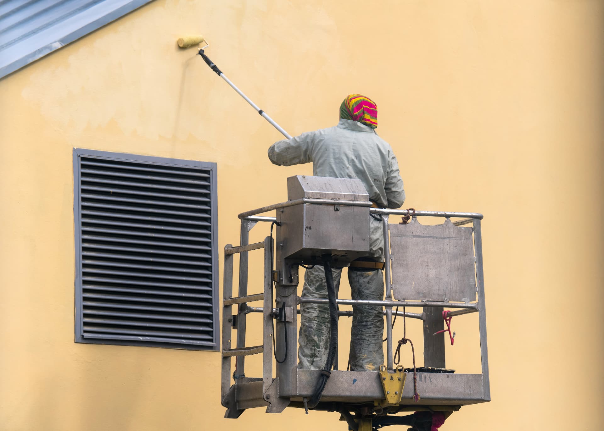 Commercial exterior painting from a lift platform
