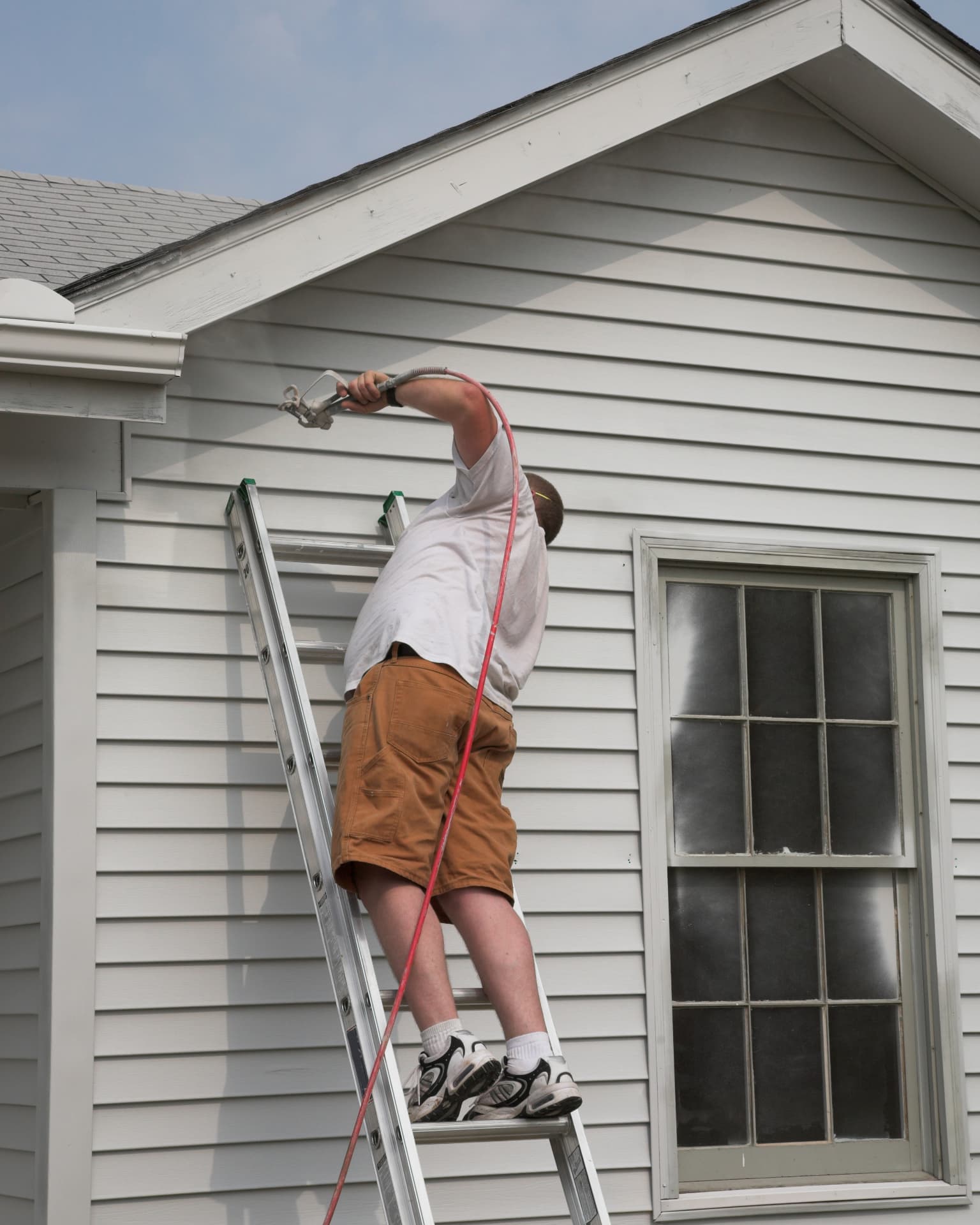 Spray application on a home exterior